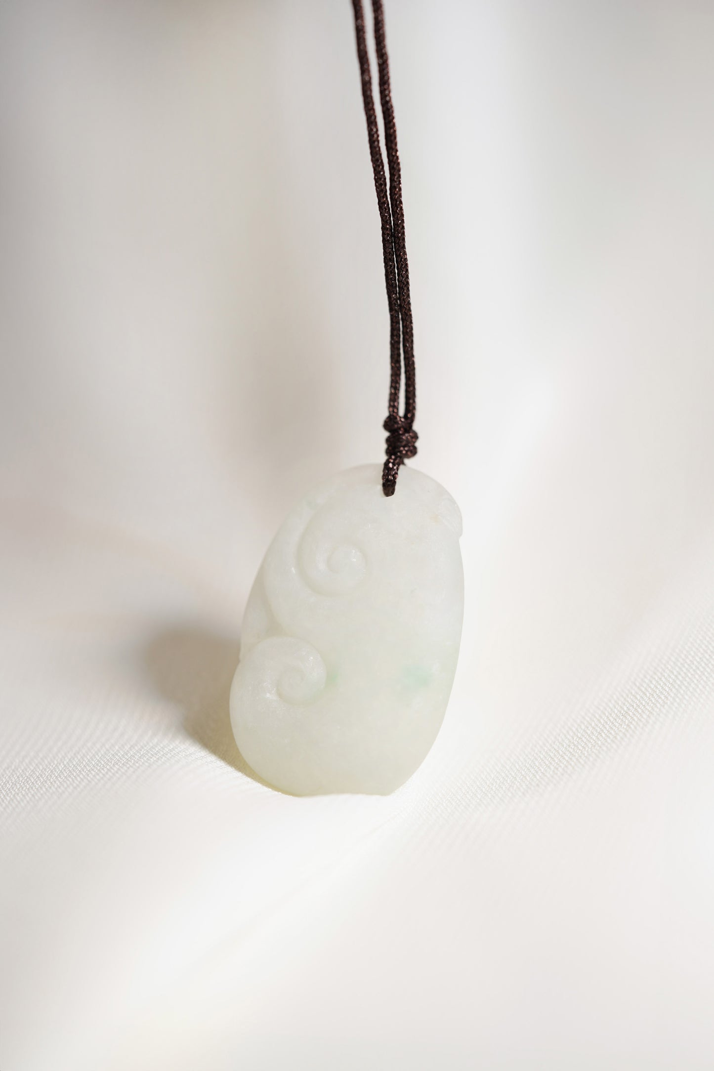 Carved White Jadeite Ruyi Pendant with Bright Green Patches