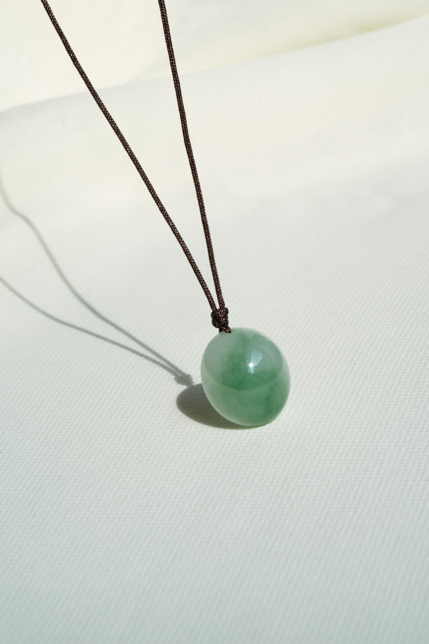 White Jadeite Egg Pendant with Yellowish Green patches