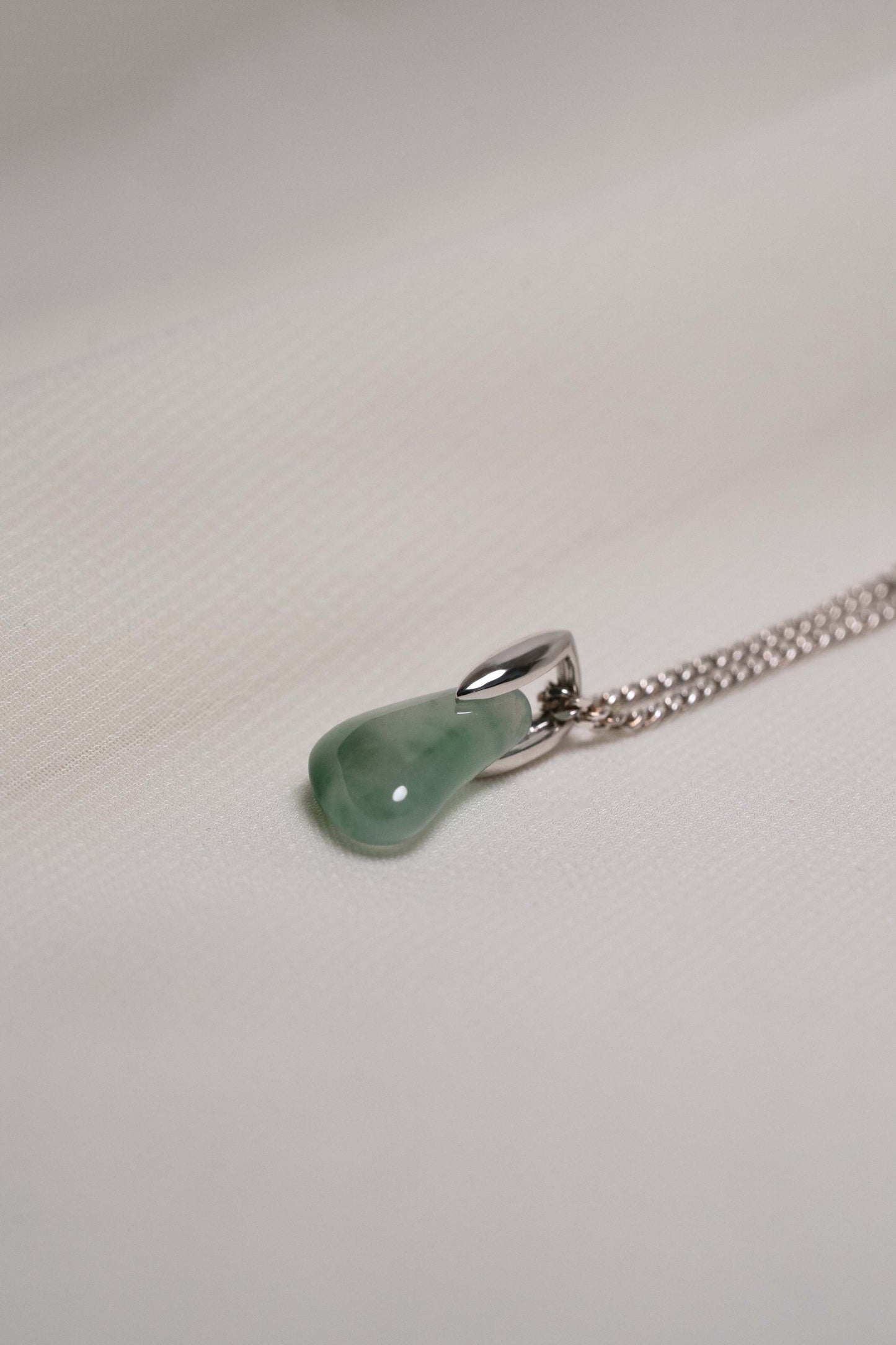 Pale Green Jadeite with Intense Green Patches with Platinum Loop hung on a 925 Silver Chain