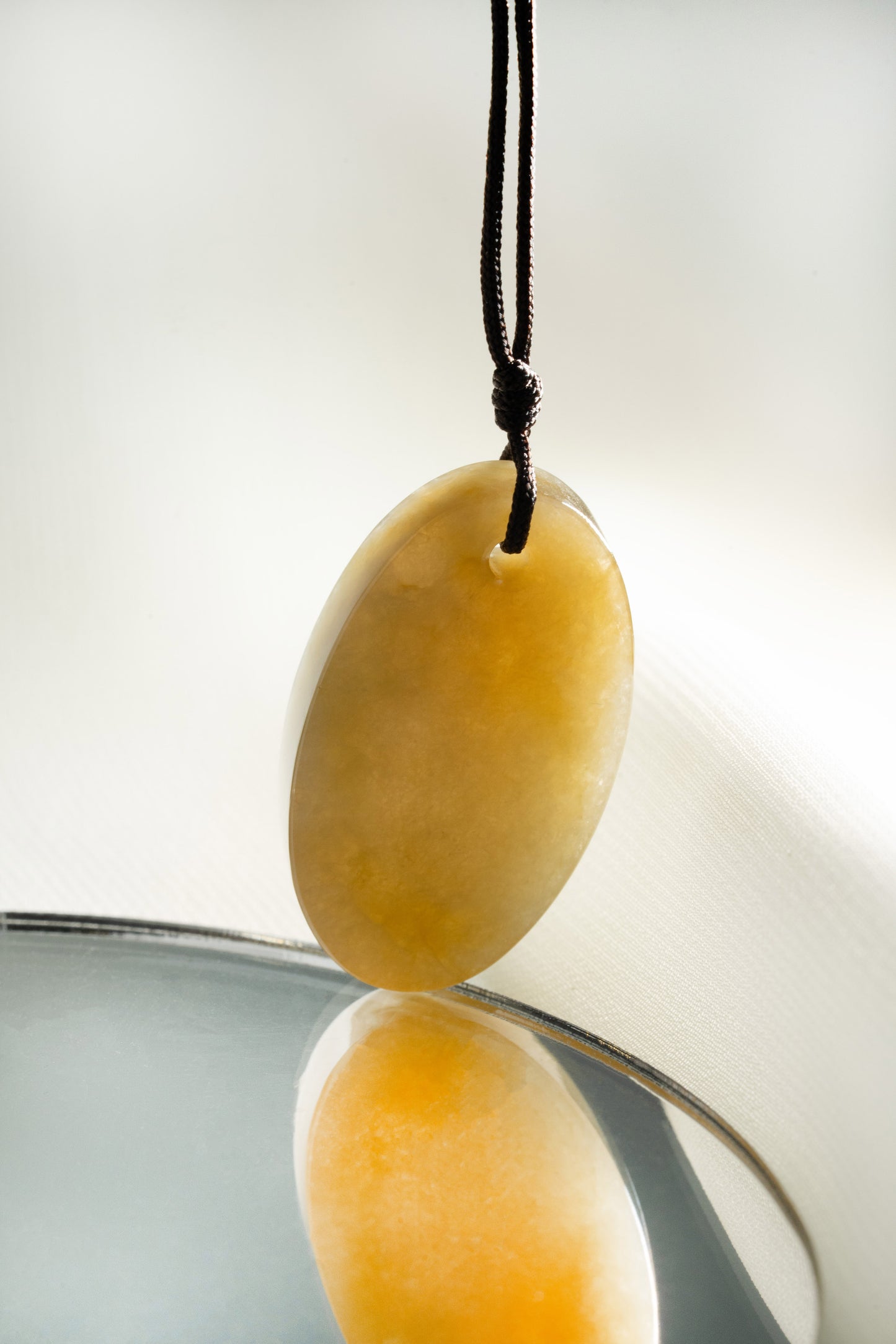 Oval Brownish Yellow Jadeite Tag with White patches