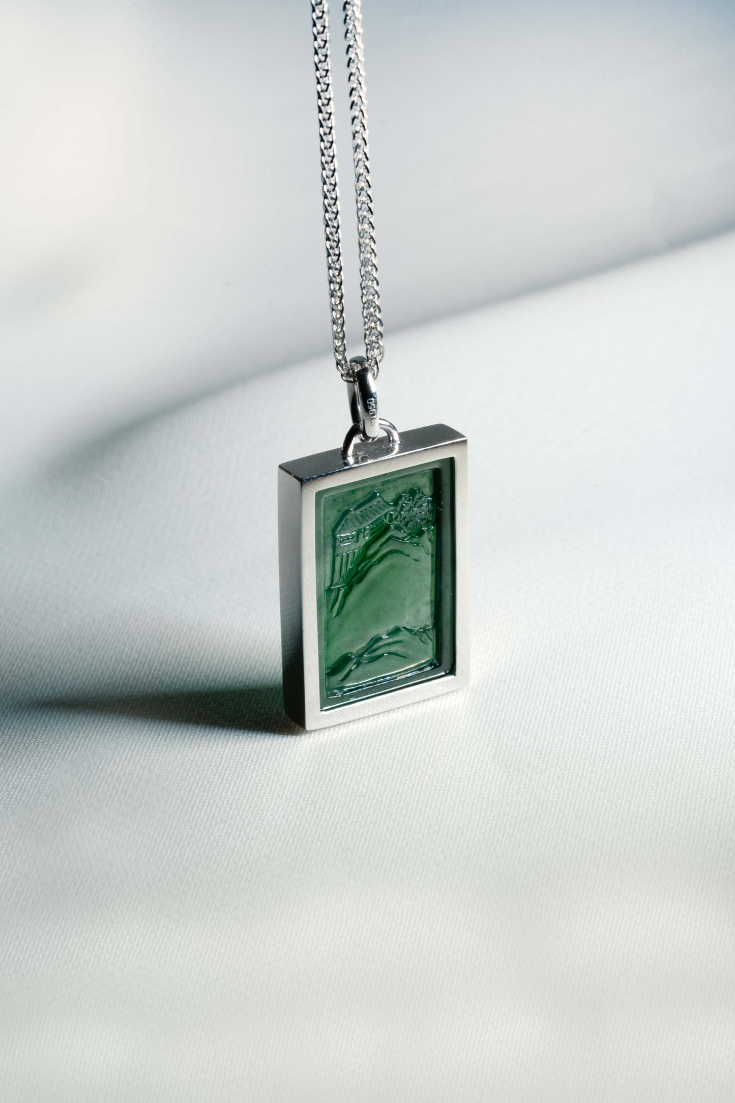 Carved Bluish Green Jadeite Tag with Platinum Frame hung on a 925 Silver Chain