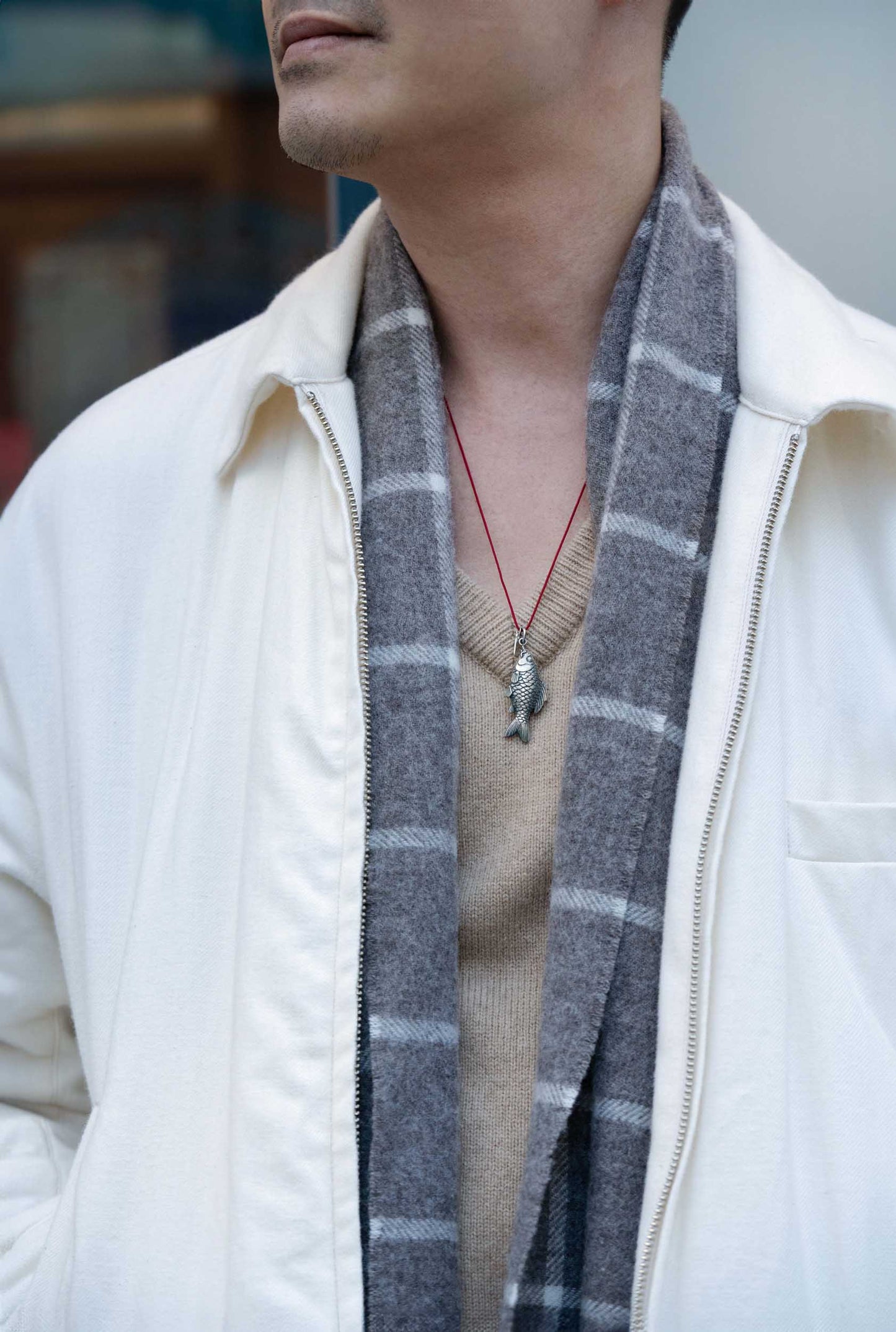 Aged Finish Silver Carved Fish Pendant with Meilan Tag hung on a red rope