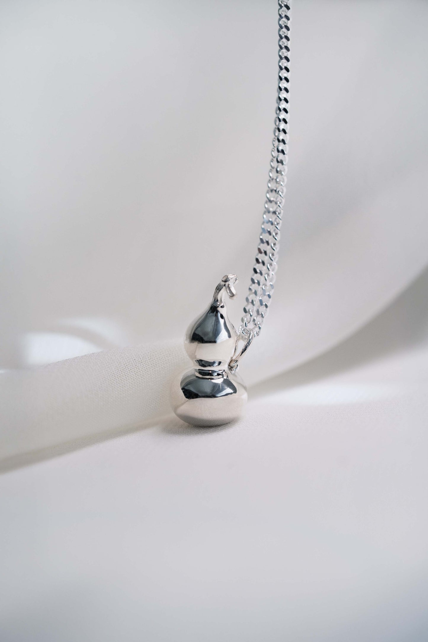 Sterling Silver Wulu Pendant hung on a 925 Silver Chain
