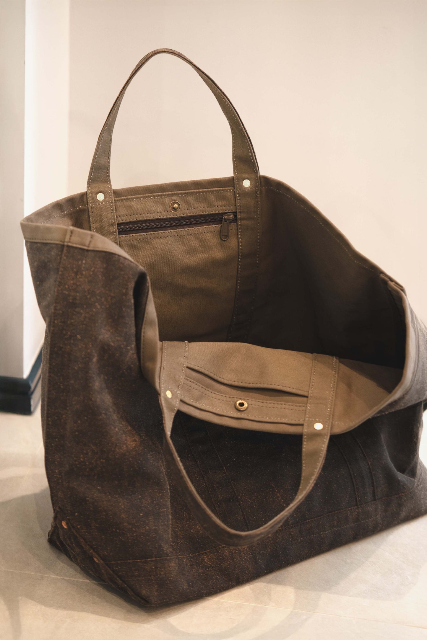 Brown Mud Silk Tote with multiple pockets on a light background