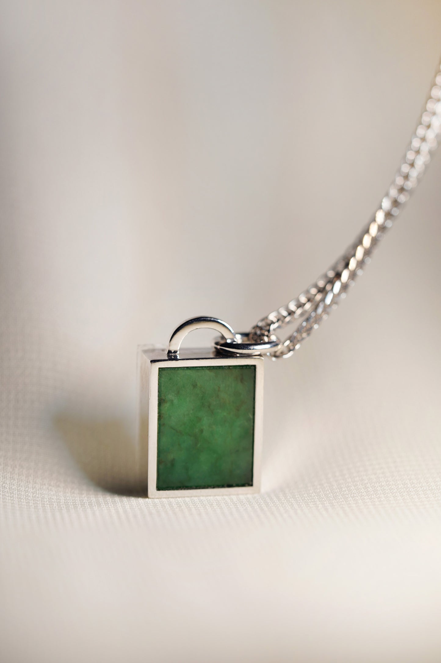 Intense Green Jadeite Tag with 18K White Gold Pendant hung on a 925 Silver Chain 