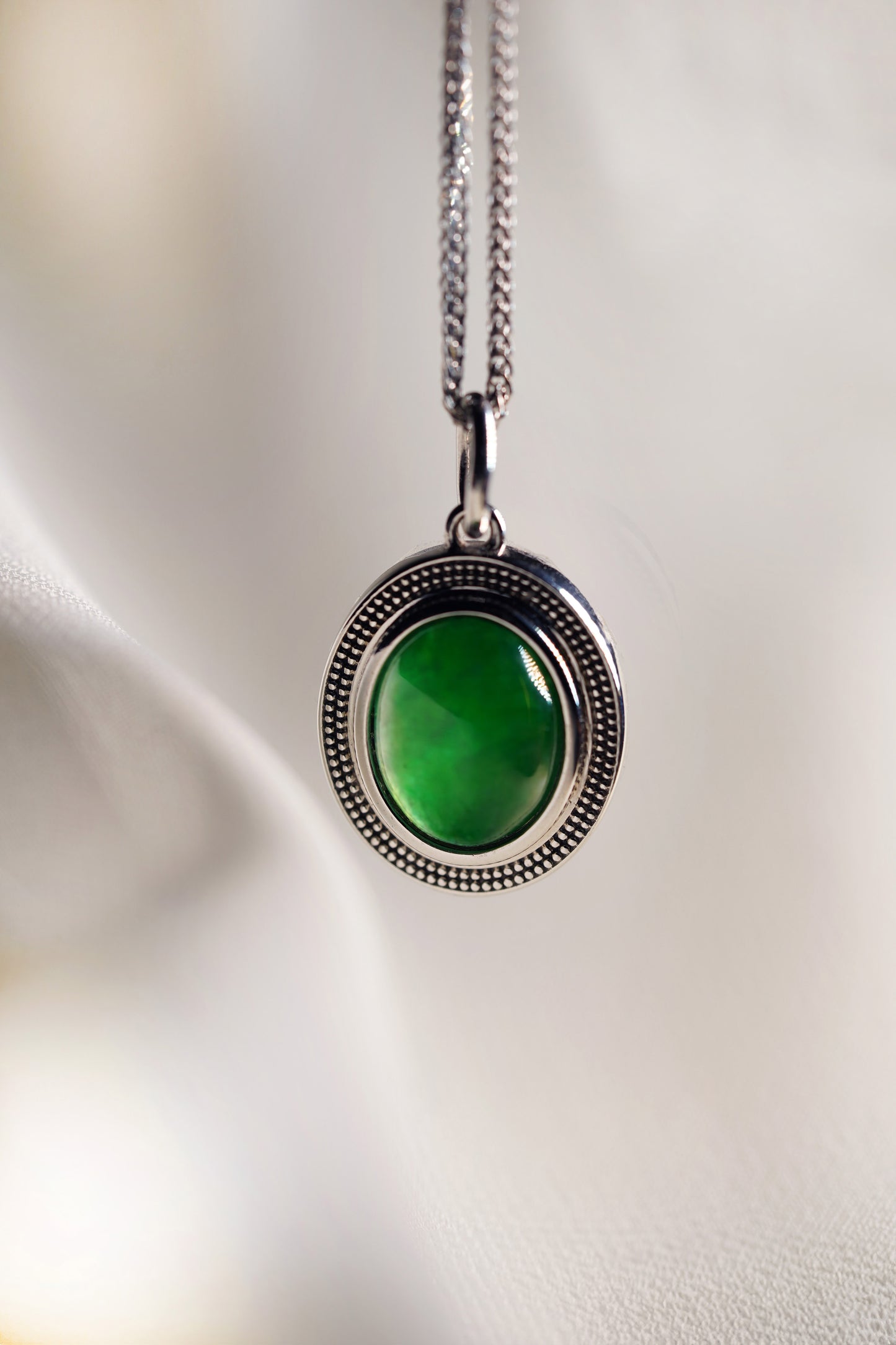 Oval Intense Green Jadeite with 18K White Gold Pendant hung on a 925 Silver Chain