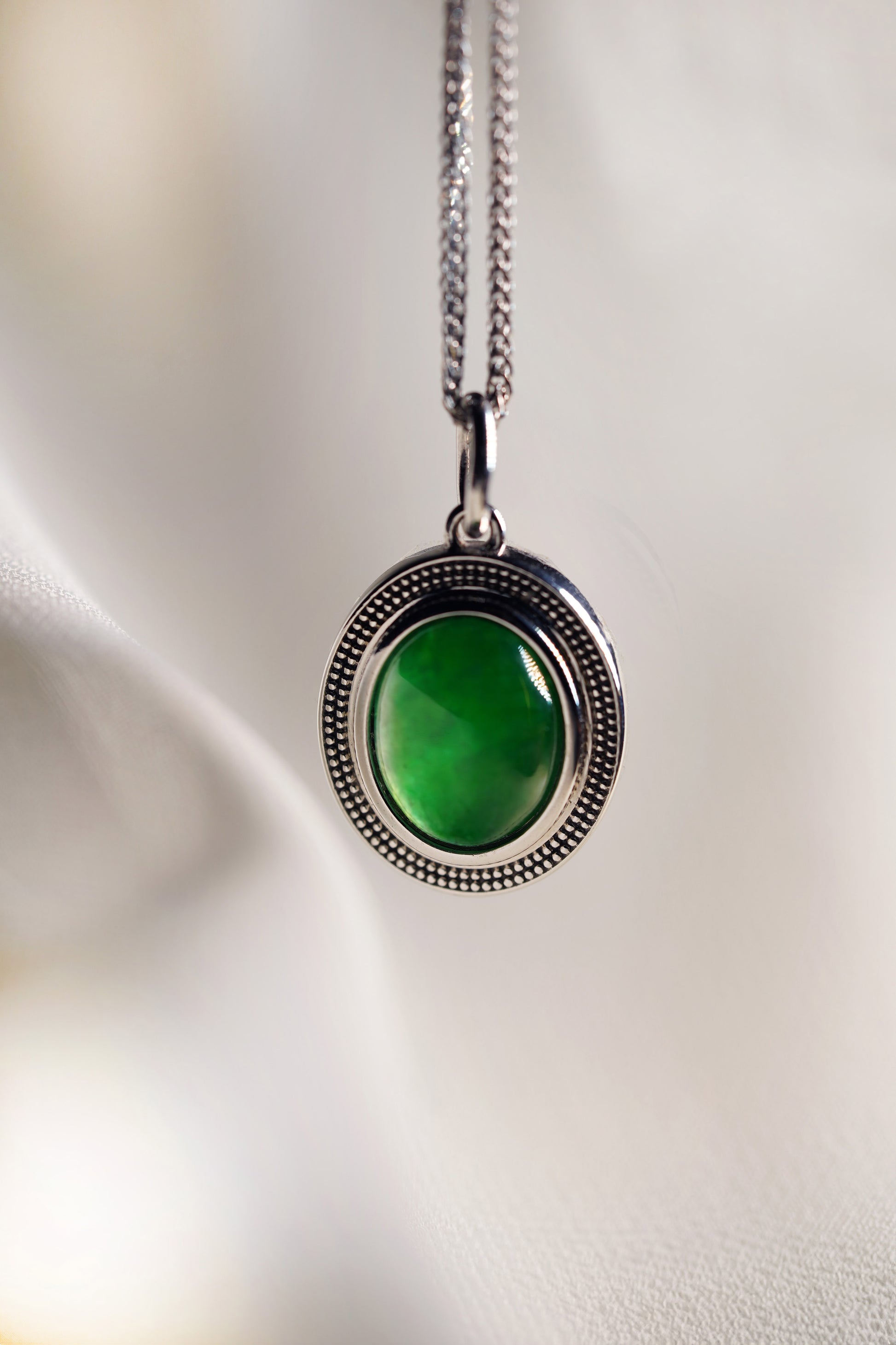 Oval Intense Green Jadeite with 18K White Gold Pendant hung on a 925 Silver Chain