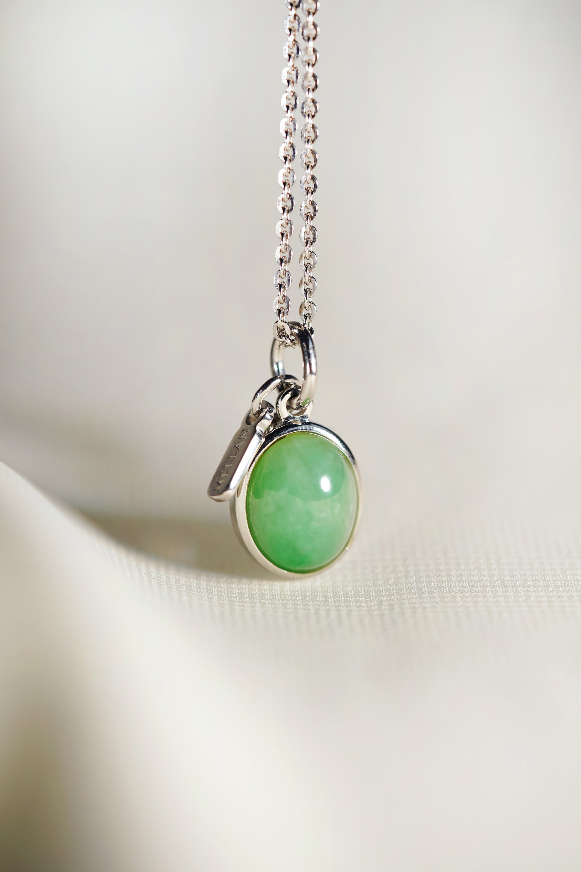 Oval Pale Green Jadeite with Light Green patches with 18K White Gold Pendant hung on a 925 Silver Chain