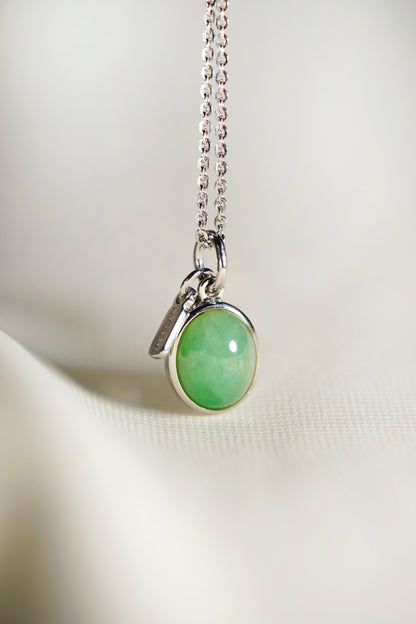 Oval Pale Green Jadeite with Light Green patches with 18K White Gold Pendant hung on a 925 Silver Chain