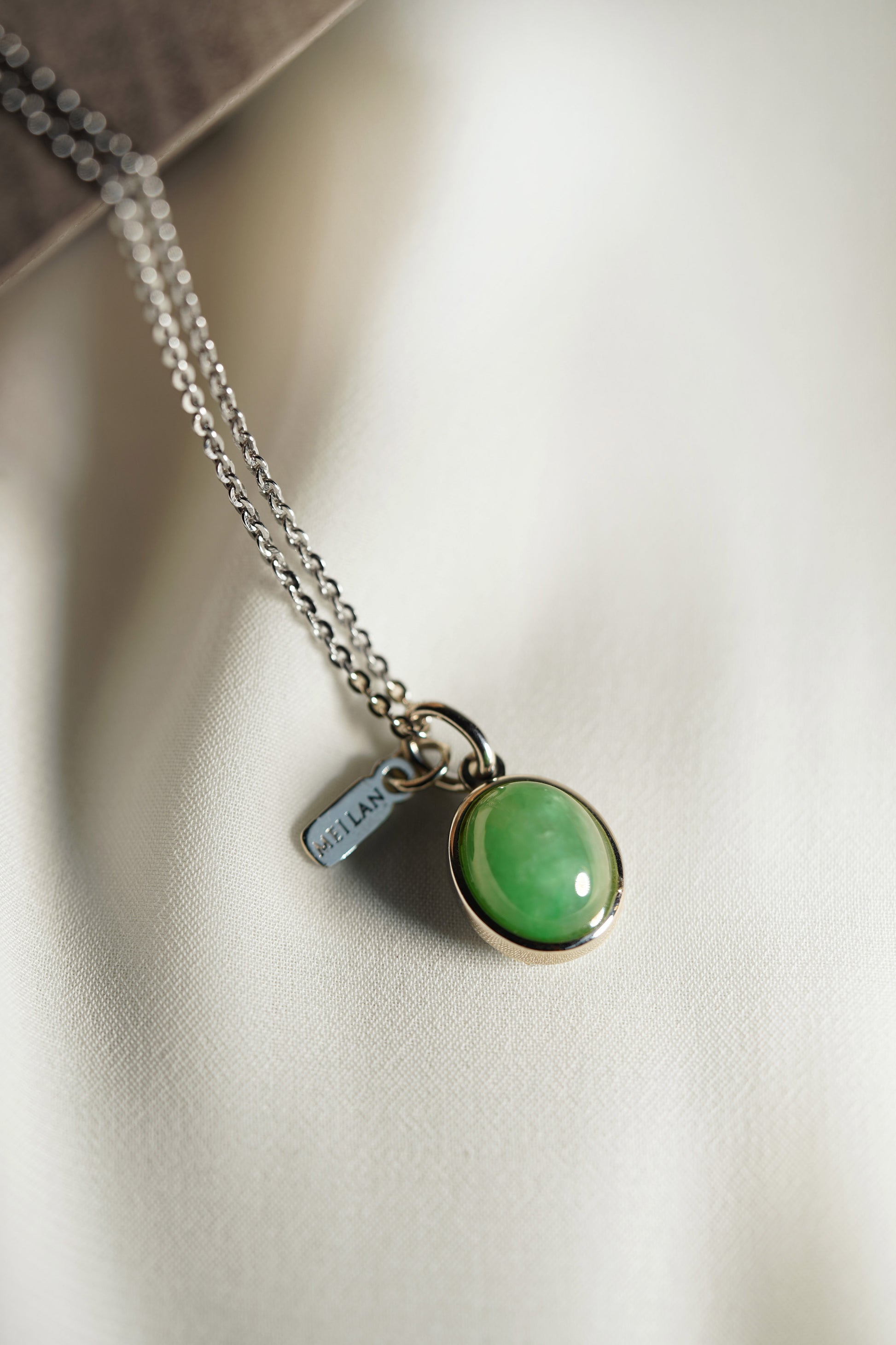 Oval Pale Green Jadeite with Light Green patches with 18K White Gold Pendant hung on a 925 Silver Chain