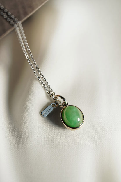 Oval Pale Green Jadeite with Light Green patches with 18K White Gold Pendant hung on a 925 Silver Chain