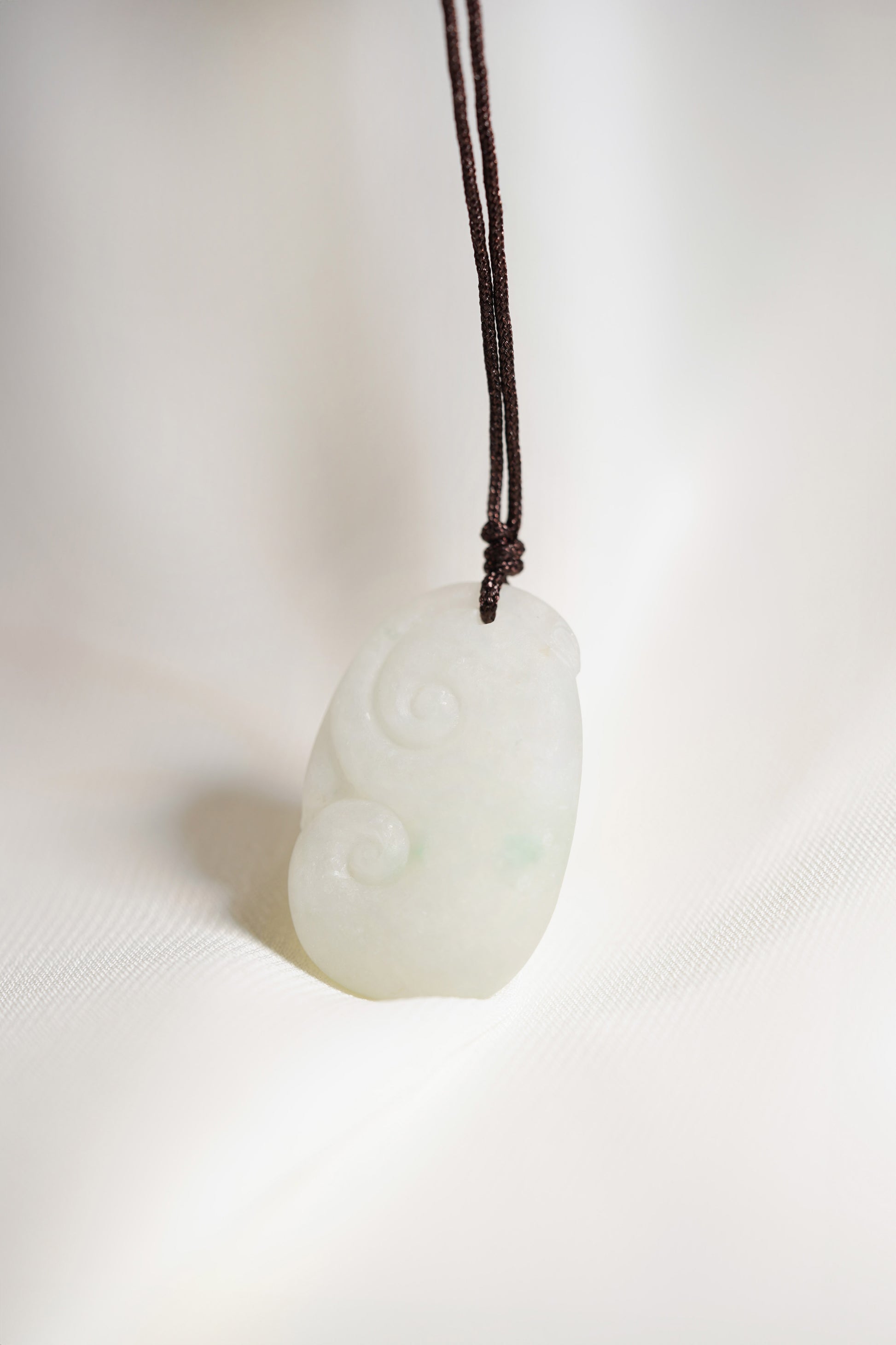 Carved White Jadeite Ruyi Pendant with Bright Green Patches