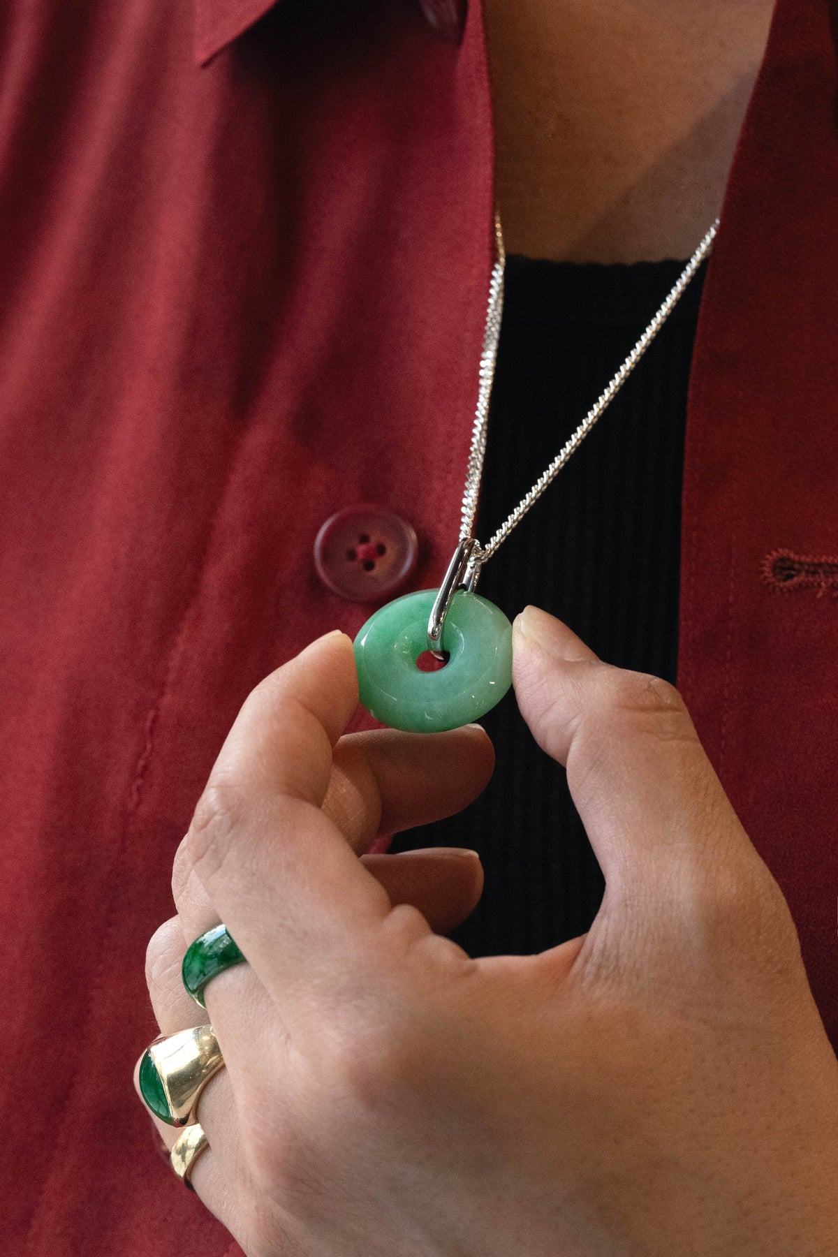 Pale Green Jadeite with Medium and Intense Green patches Zen Doughnut Pendant with 14K White Gold Loop hangs on a 925 Silver Chain matches with a Red Silk Shirt 