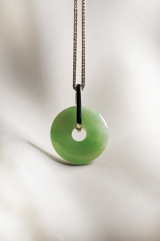 Pale Green Jadeite Zen Doughnut Pendant with Light Green patches added with a Platinum Loop hung on a 925 Silver Chain