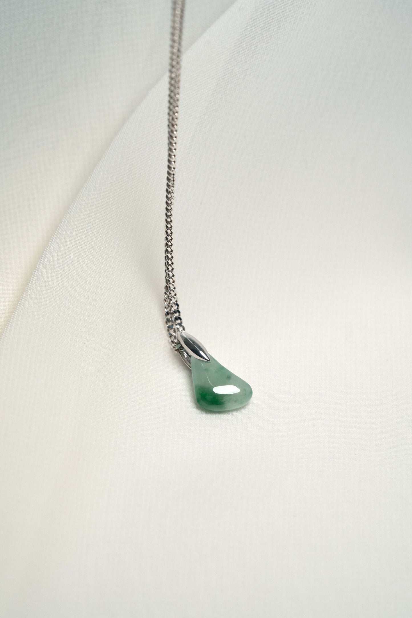 Pale Green Jadeite with Intense Green Patches with Platinum Loop hung on a 925 Silver Chain