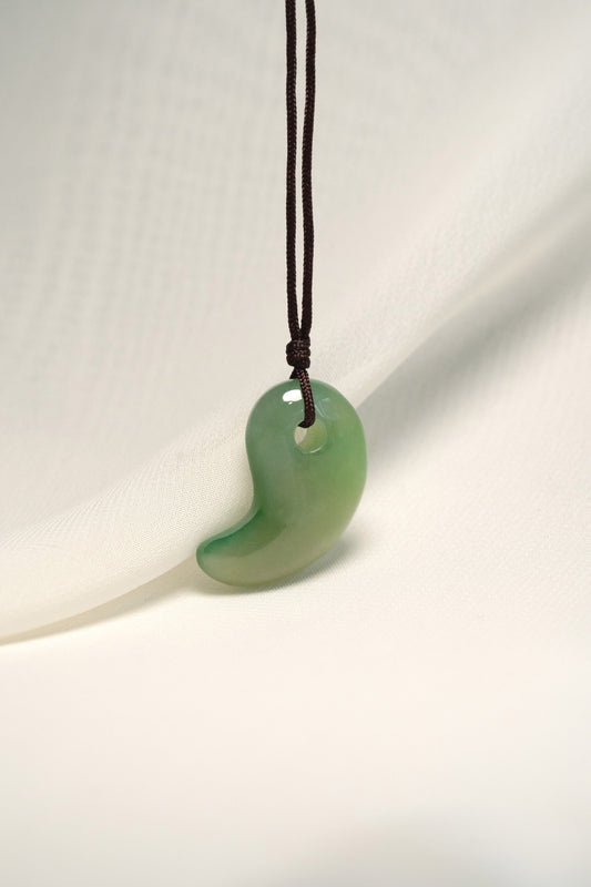 Medium Green Jadeite Magatama Pendant hangs on a String