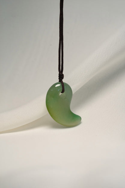 Medium Green Jadeite Magatama Pendant hangs on a String
