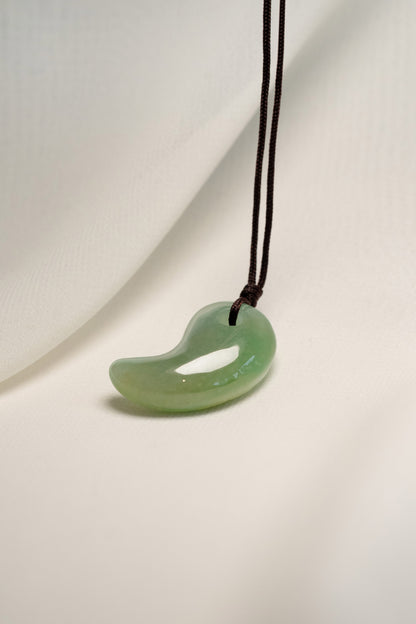 Medium Green Jadeite Magatama Pendant hangs on a String