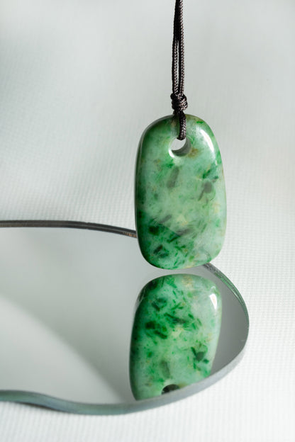 Pale Green Oval Jadeite Tag with Bright and Intense Green Patches