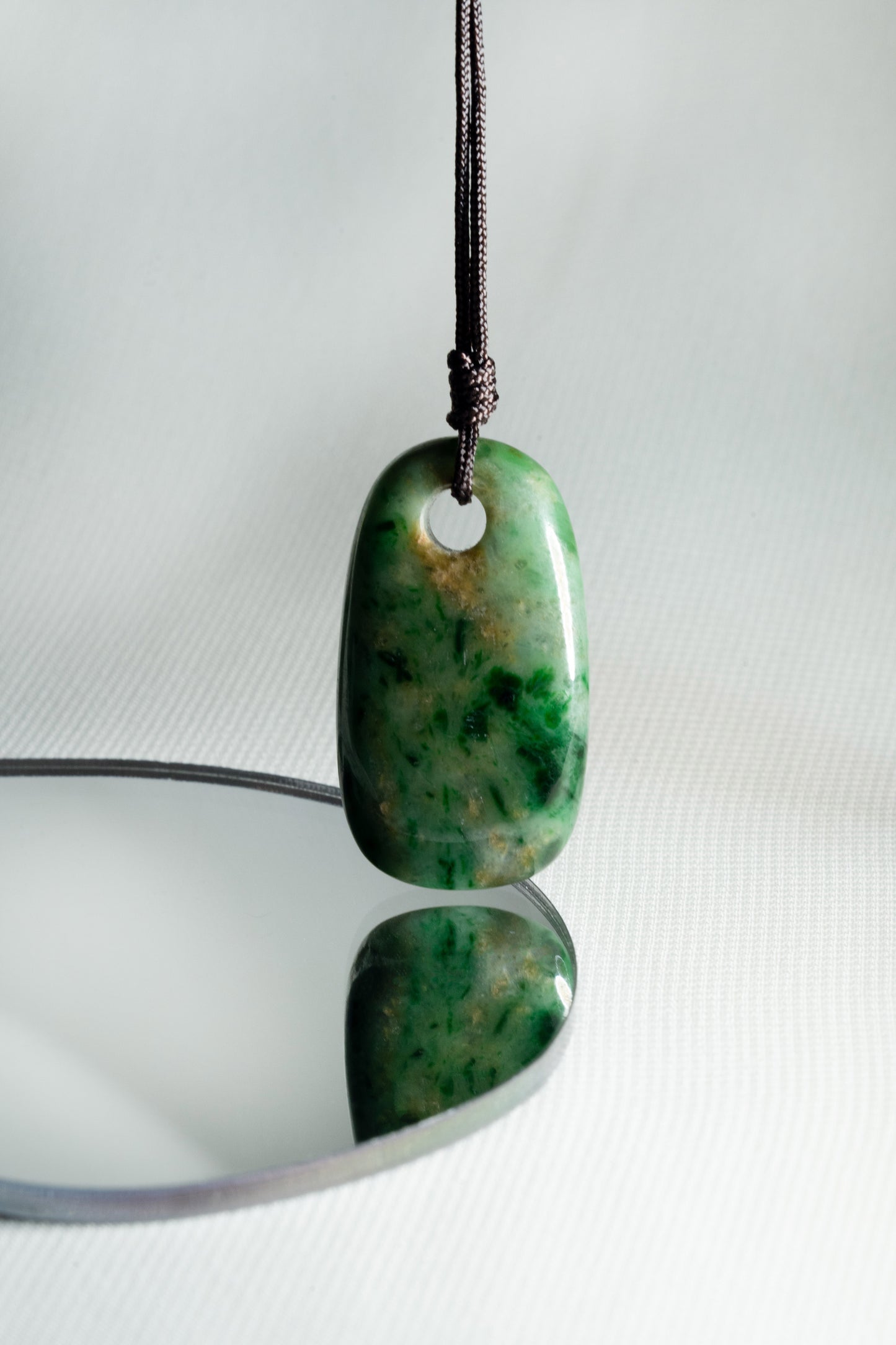 Pale Green Oval Jadeite Tag with Bright and Intense Green Patches