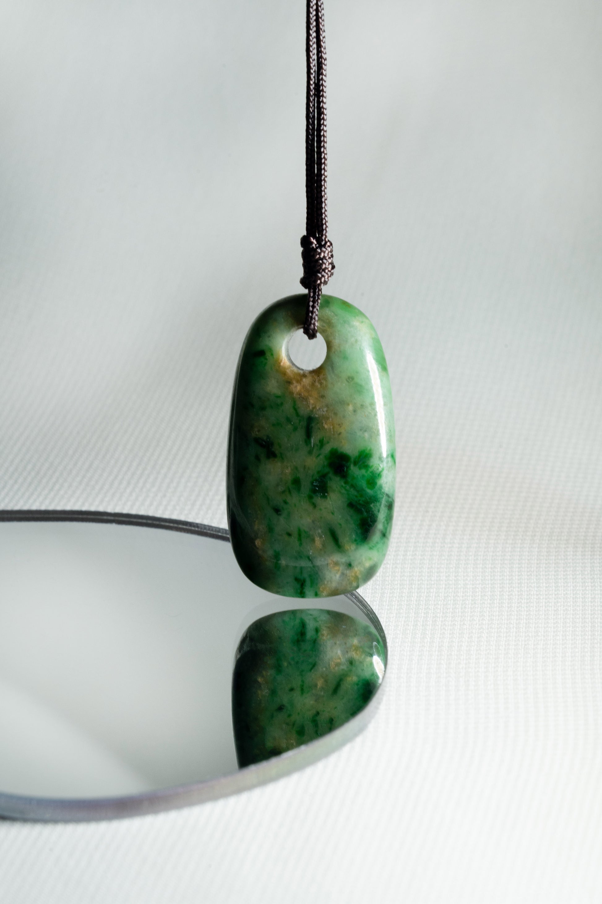 Pale Green Oval Jadeite Tag with Bright and Intense Green Patches