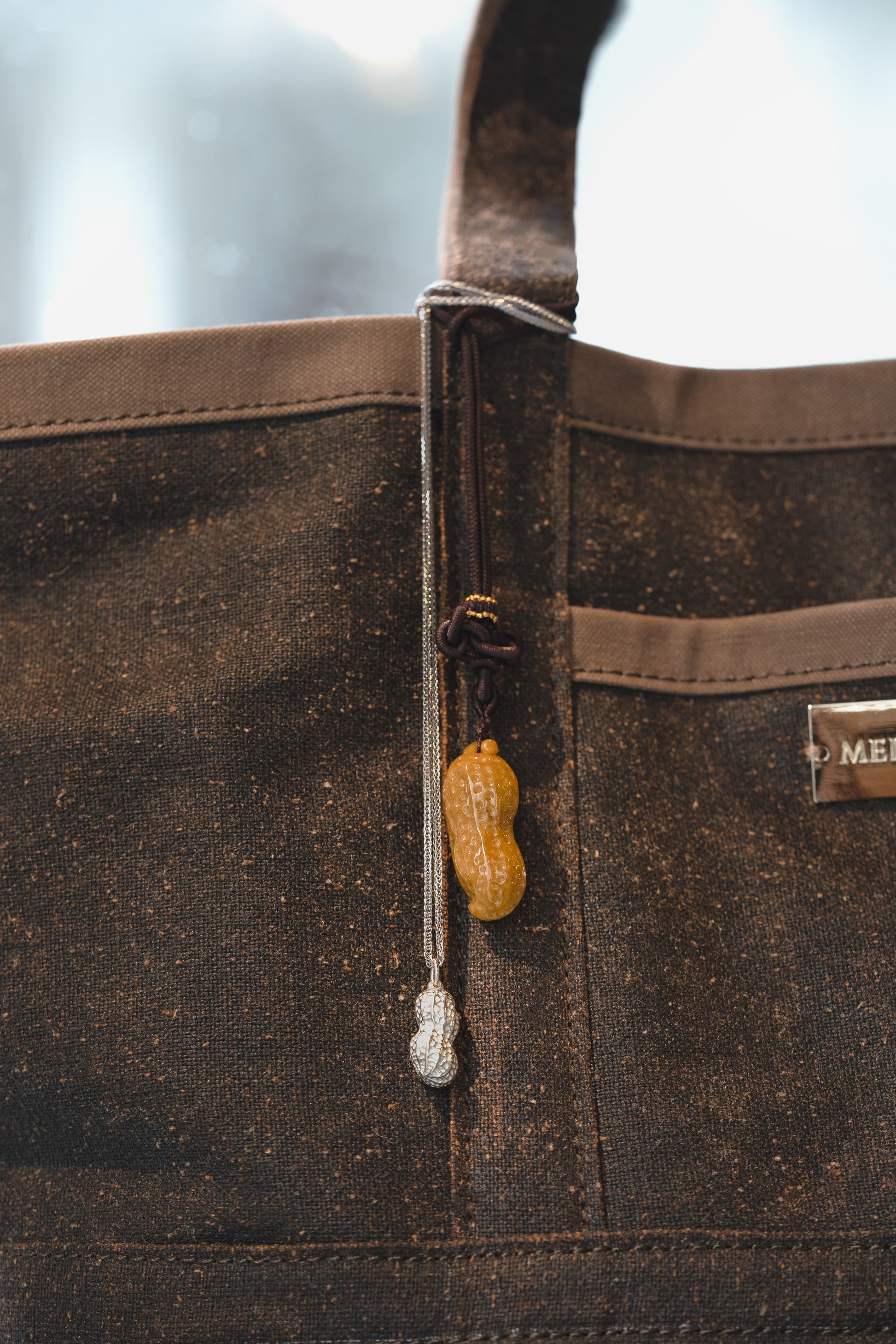 Jadeite Carved Peanut and Silver Peanut hung on a Silk Tote Bag