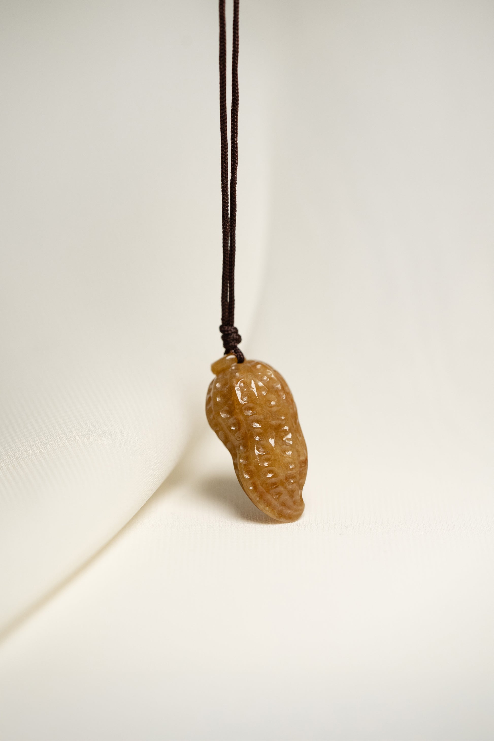 Brownish Yellow Carved Jadeite Peanut Pendant in Small Size with Adjustable Knot