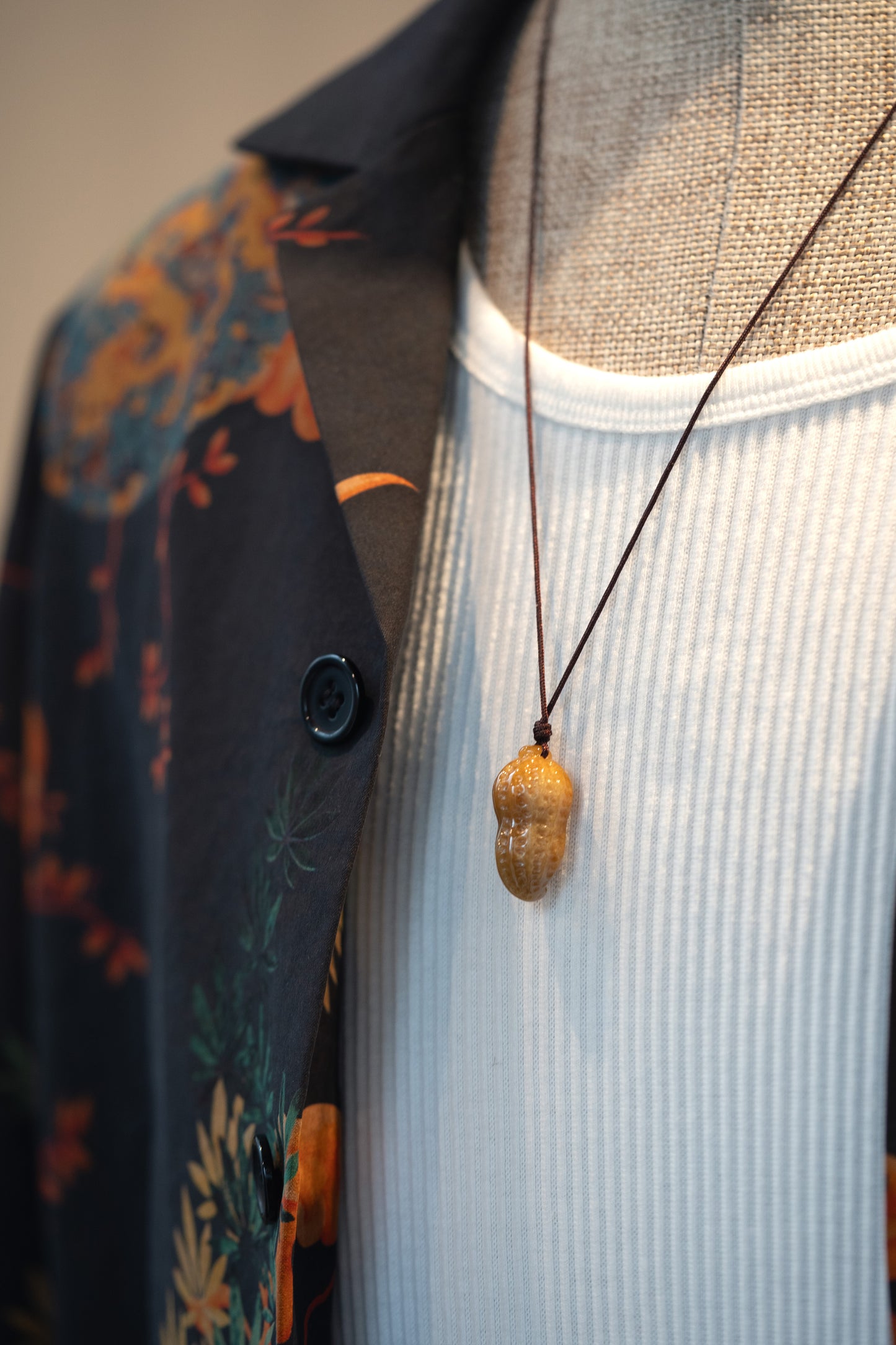 Brownish Yellow Carved Jadeite Peanut Pendant in Small Size with Adjustable Knot styles with Navy Short Sleeve Silk Shirt with Dragon Cloud 