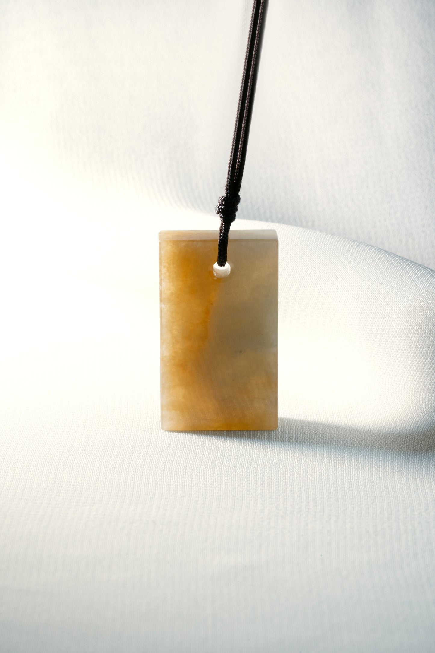 Brownish Yellow Jadeite Tag with White Patches
