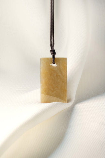 Brownish Yellow Jadeite Tag with White Patches