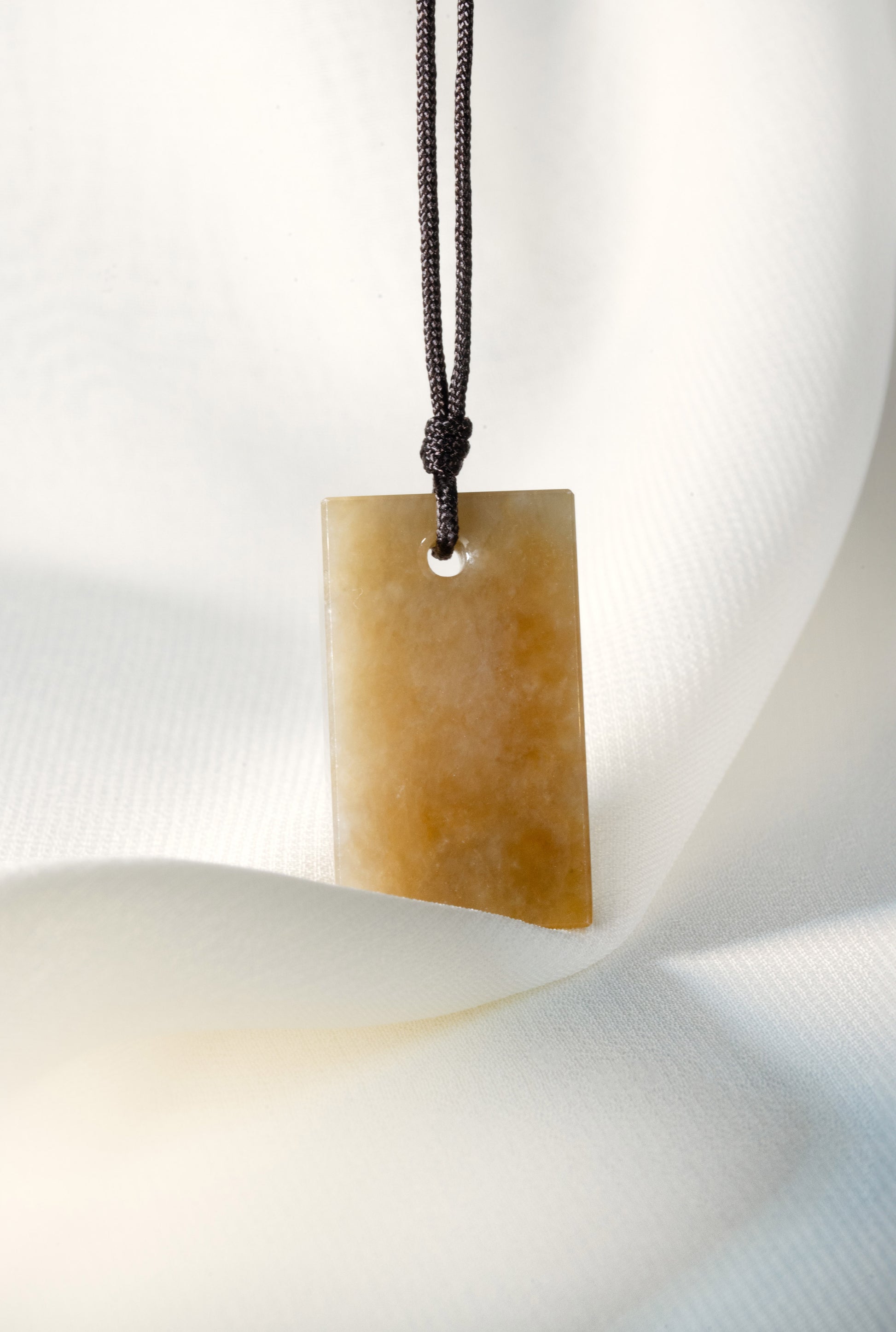 Brownish Yellow Jadeite Tag with White Patches