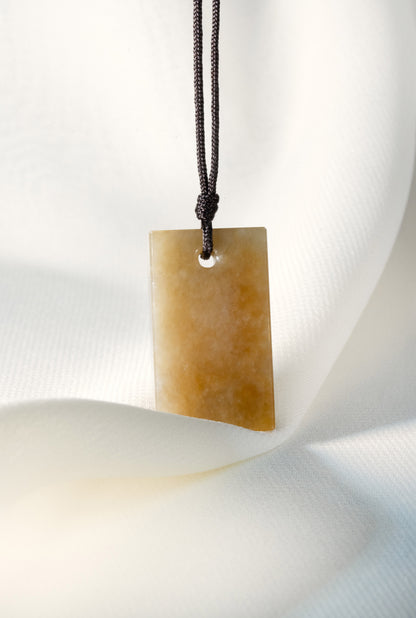 Brownish Yellow Jadeite Tag with White Patches