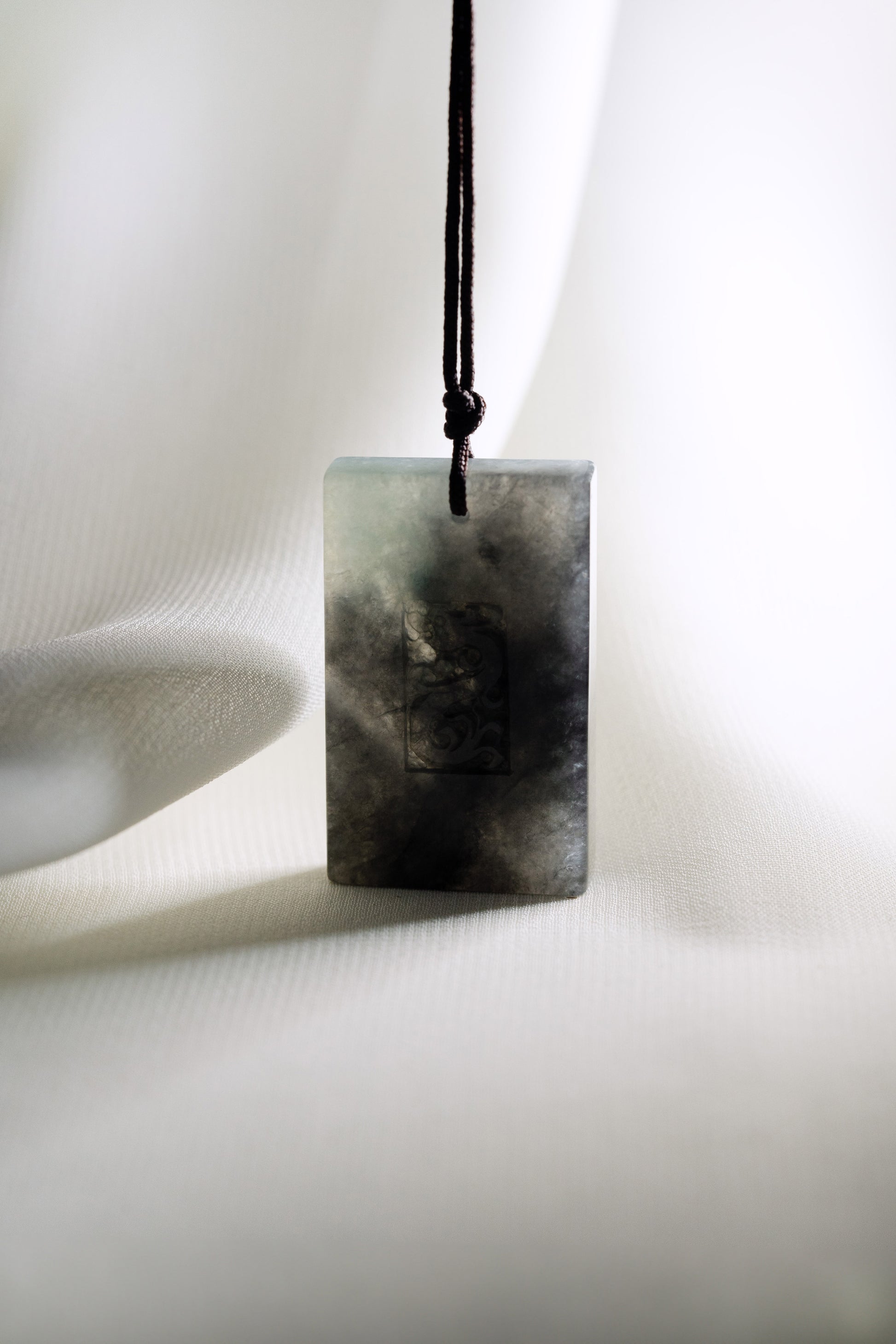 Black Jadeite Engraved Dragon Tag with Pale Green and Grey patches