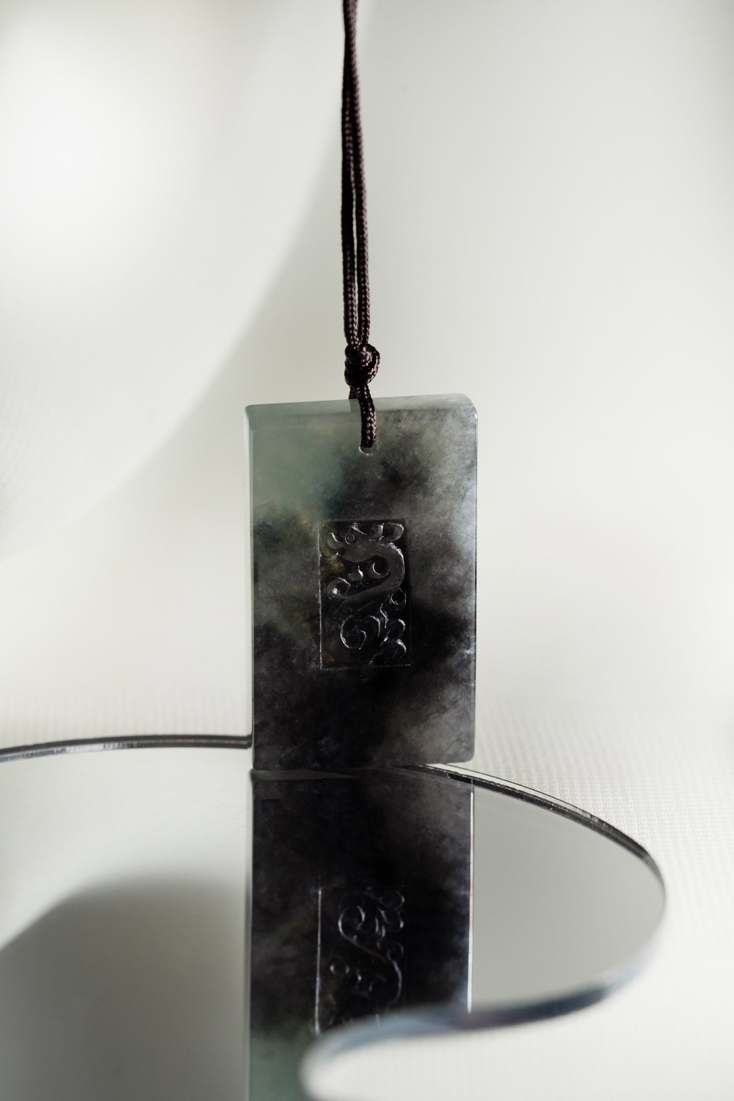 Black Jadeite Engraved Dragon Tag with Pale Green and Grey patches