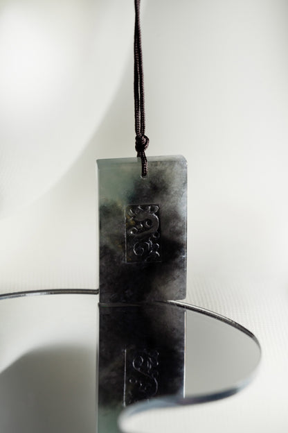 Black Jadeite Engraved Dragon Tag with Pale Green and Grey patches