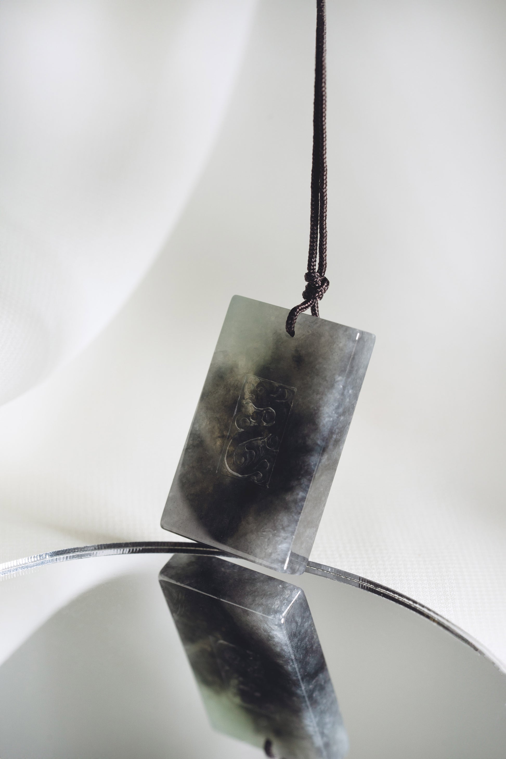 Black Jadeite Engraved Dragon Tag with Pale Green and Grey patches