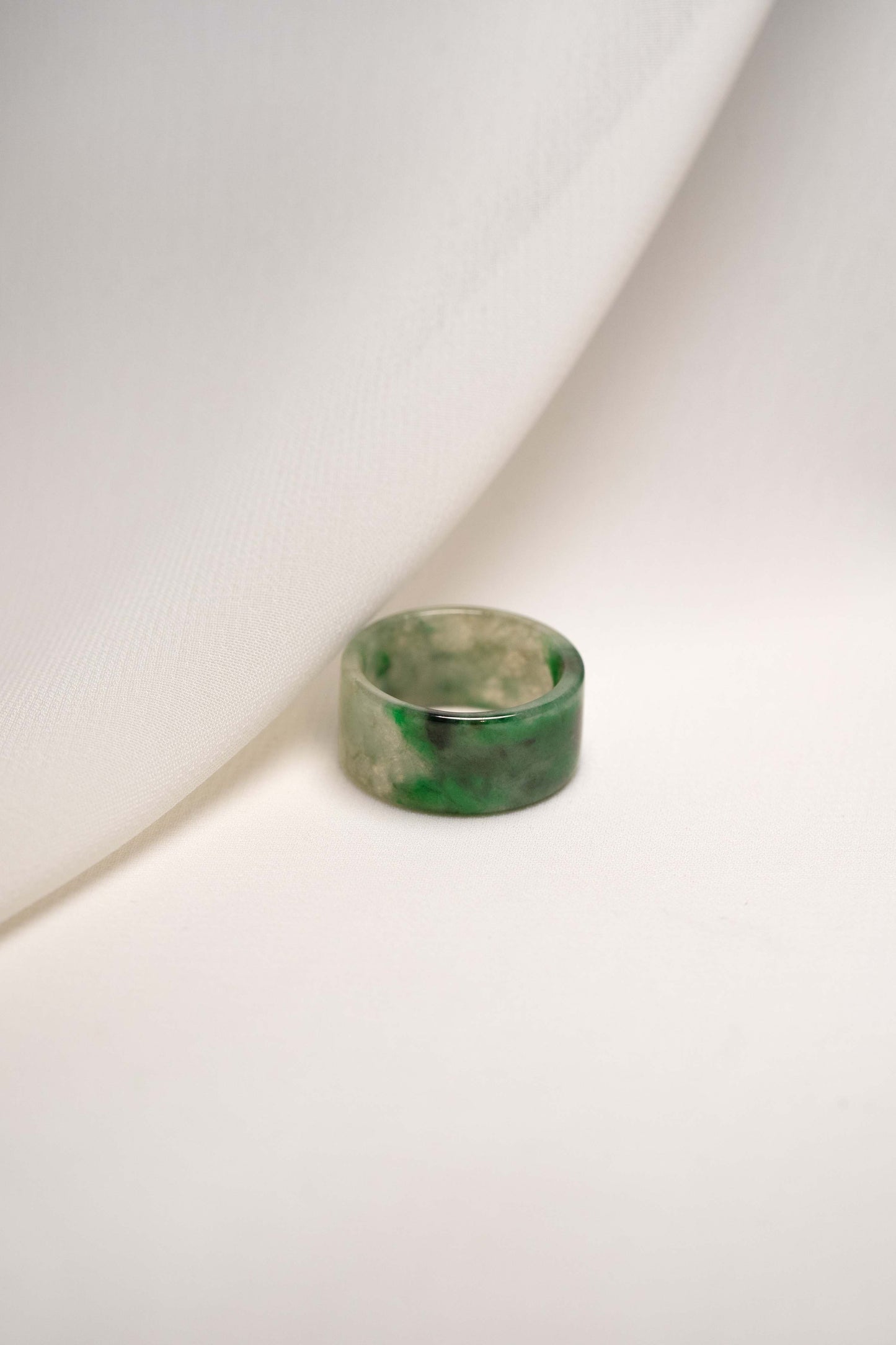 White Jadeite Ring with Medium Green and Black Patches