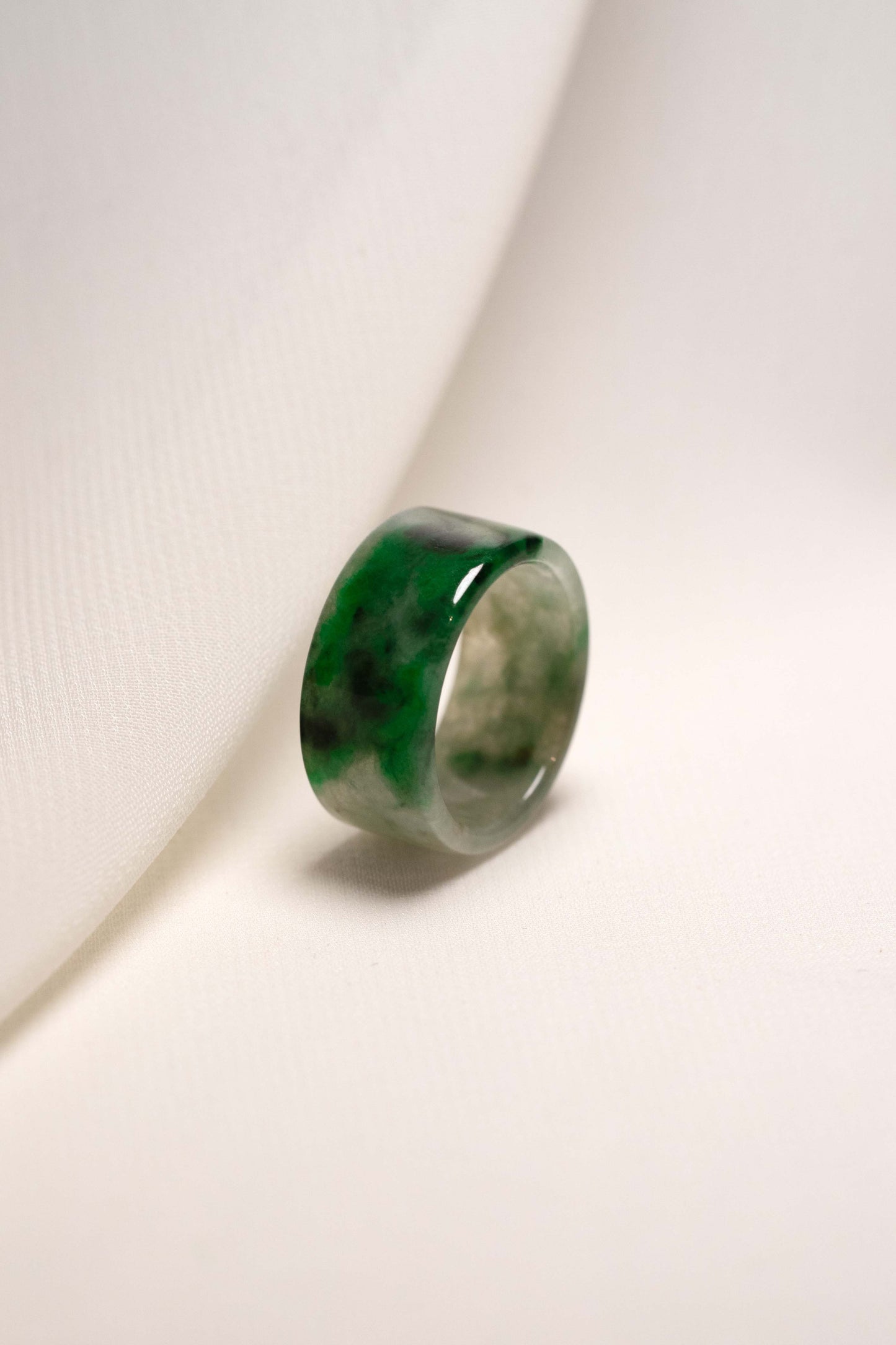 White Jadeite Ring with Medium Green and Black Patches