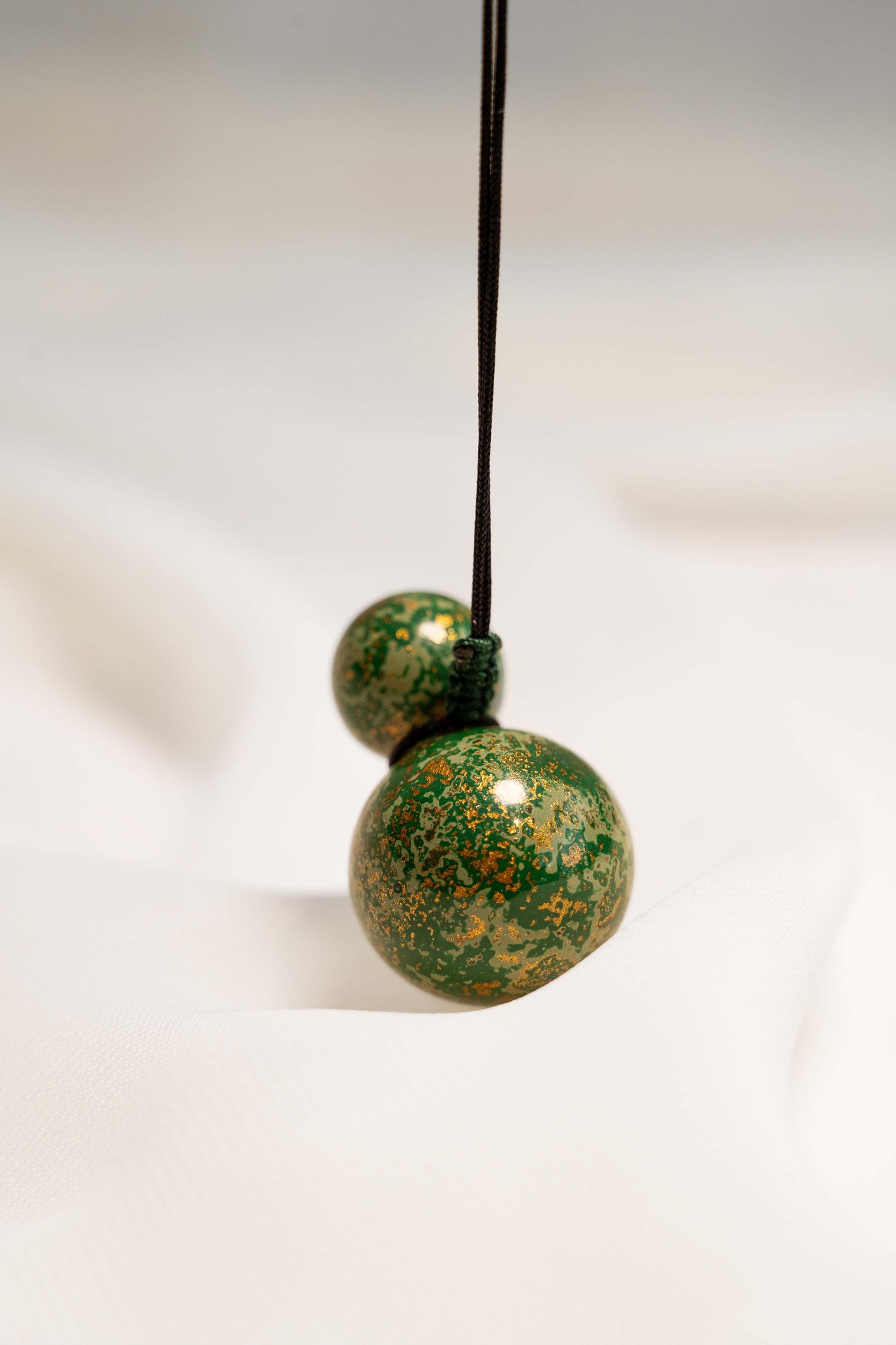 Green Multicolored Lacquer Wulu Pendant  hung on a string