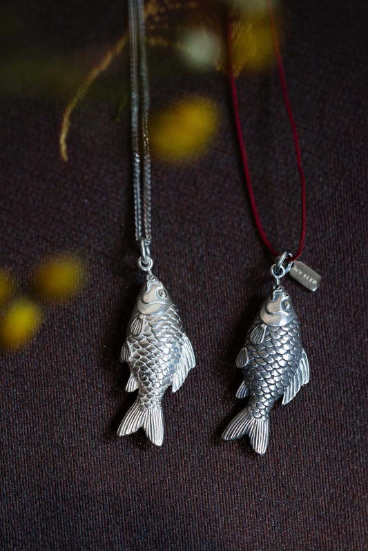 High Shine Finish 925 Silver Carved Fish Pendant hung on a Sterling Silver Chain
Aged Finish Silver Carved Fish Pendant with Meilan Tag hung on a red rope