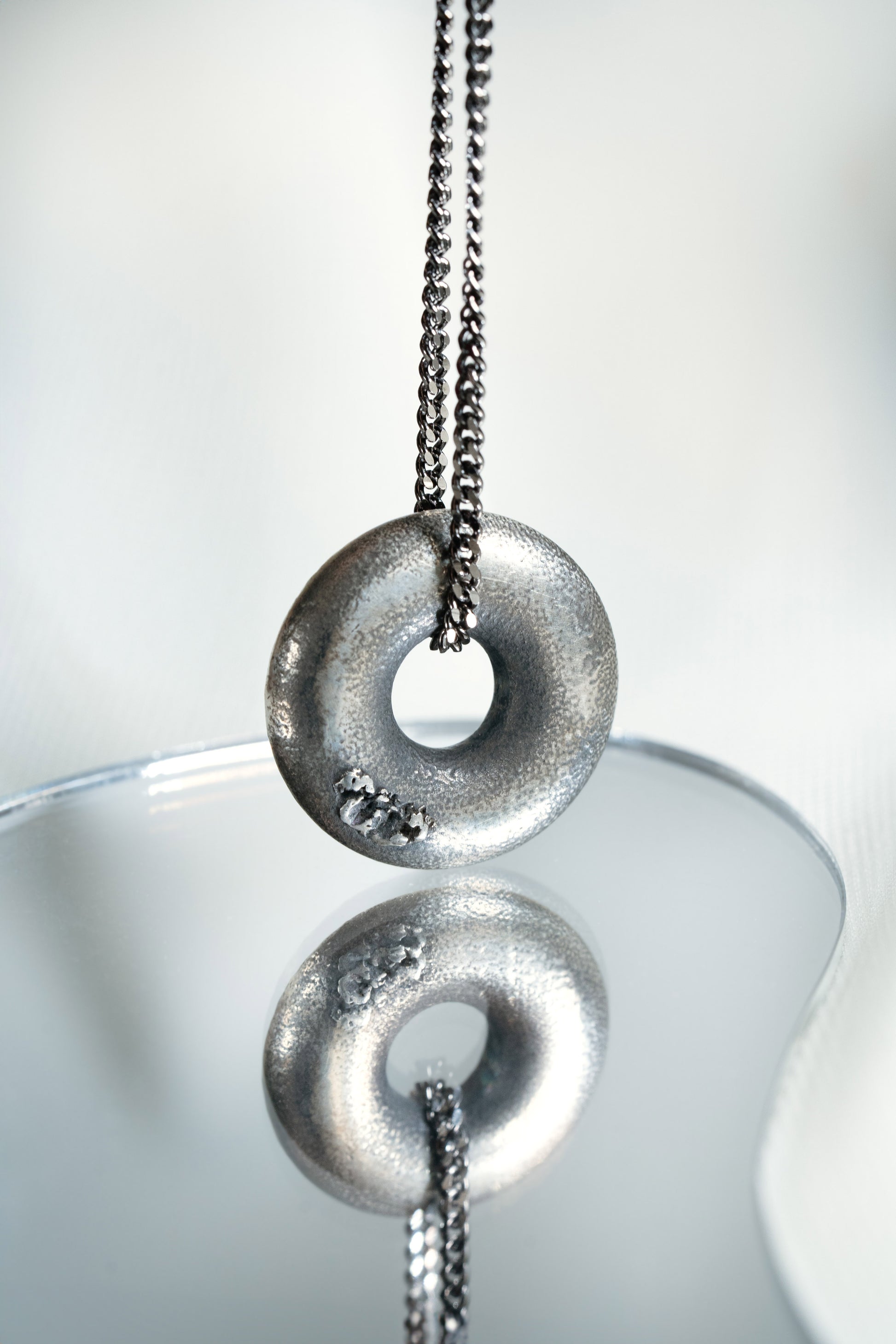 Sterling Silver Zen Doughnut Pendant hung on a Black 925 Silver Chain