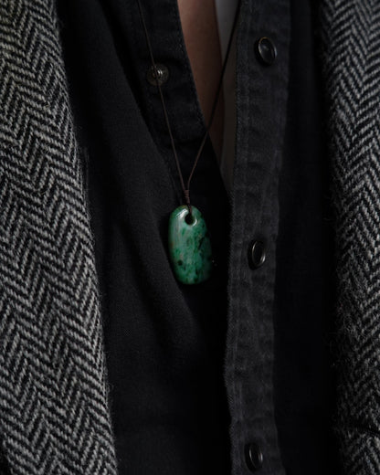 Pale Green Oval Jadeite Tag with Bright and Intense Green Patches